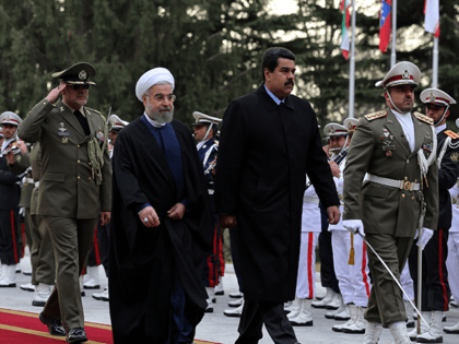 Iranian President Hassan Rouhani (2L) and Venezuelan President Nicolas Maduro (3L) review