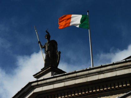 DUBLIN, IRELAND - MARCH 27: The Irish tricolour flies over the GPO during the 1916 Easter Rising commemoration parade marking the 100th anniversary at the General Post Office building on March 27, 2016 in Dublin, Ireland. The 1916 rebellion was an attempt by Irish forces to overthrow the British government …