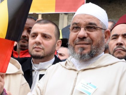 Members of the Muslim Community of Belgium, including Molenbeek Imam, Cheik Mohamed Toujgani (R), take part in a tribute, called by Muslim organizations, to the victims of the March 22 Brussels terror attacks on April 9, 2016, outside of Maelbeek / Maalbeek metro station, Brussels. On March 22, two bombs …