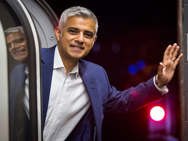 LONDON, ENGLAND - AUGUST 20: London Mayor Sadiq Khan waves from the first Night Tube trai