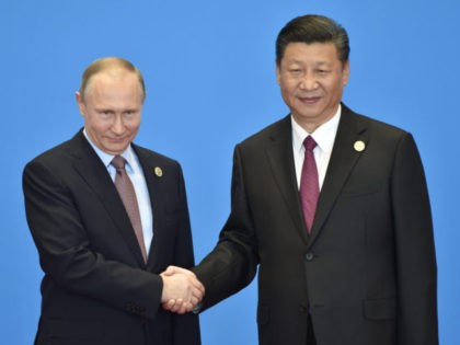 BEIJING, CHINA - MAY 15: Russian President Vladimir Putin (L) shakes hands with Chinese President Xi Jinping during the welcome ceremony for the Belt and Road Forum, at the International Conference Center on May 15, 2017 in Yanqi Lake, north of Beijing, China. (Photo by Kenzaburo Fukuhara-Pool/Getty Images)