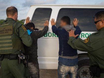 Border Patrol agents arrest a group of migrants near the Texas border with Mexico. (File Photo: LOREN ELLIOTT/AFP via Getty Images)
