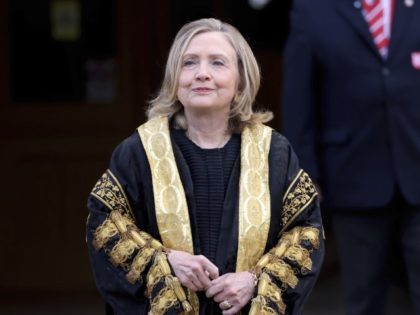 Former US Secretary of State Hillary Clinton poses for a photo after being inaugarated as the first female chancellor of Queens University, in Belfast, Northern Ireland, Friday, Sept. 24, 2021.