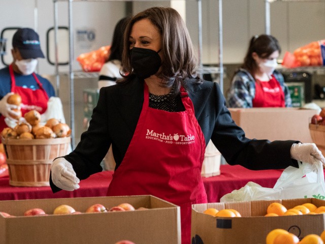 Vice President Kamala Harris fills bags with fruit and other items, at Martha's Table, Monday, Jan. 17, 2022, in Washington. (AP Photo/Alex Brandon)