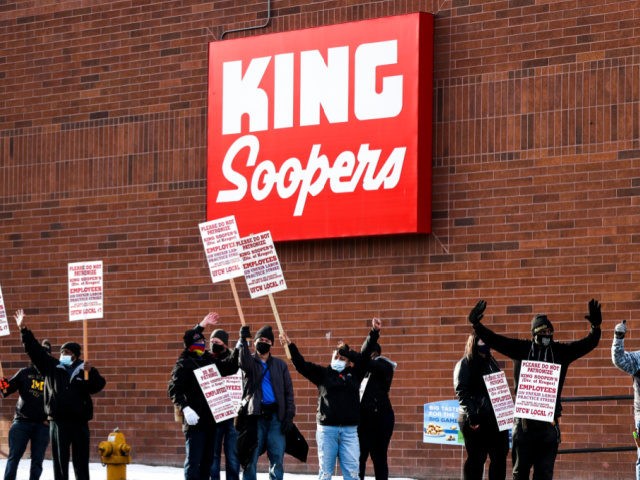 King Soopers grocery store workers wave at passing cars as they strike at more than 70 stores across the Denver metro area on January 12, 2022 in Denver, Colorado. About 7000 workers at the Kroger-owned grocery chain are set to strike for three weeks on claims of unfair labor practices. …