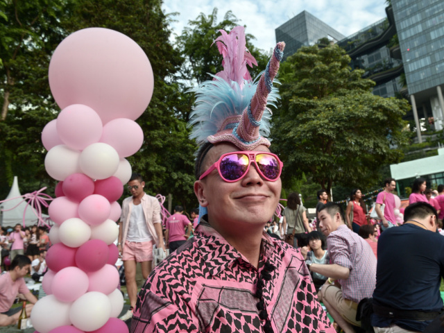 A Singaporean dresses in pink in support of gays and lesbians gather at "Speakers&#03