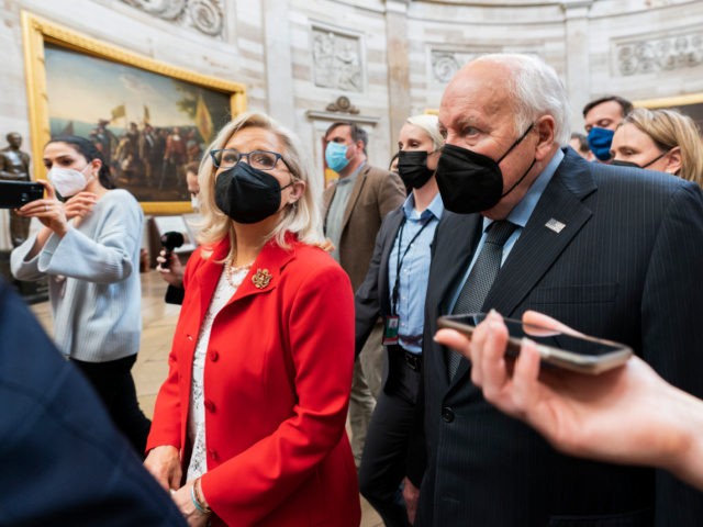 Former Vice President Dick Cheney walks with his daughter Rep. Liz Cheney, R-Wyo., vice chair of the House panel investigating the Jan. 6 U.S. Capitol insurrection, in the Capitol Rotunda at the Capitol in Washington, Thursday, Jan. 6, 2022. (AP Photo/Manuel Balce Ceneta)
