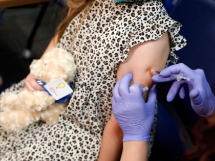 A 6 year-old child receives their first dose of the Pfizer Covid-19 vaccine at the Beaumon