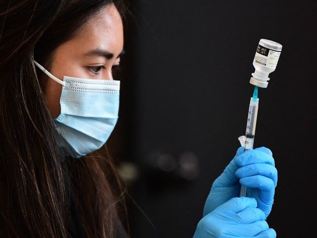 A Covid-19 vaccine is prepared for administration ahead of a free distribution of over the counter rapid Covid-19 test kits to people receiving their vaccines or boosters at Union Station in Los Angeles, California, on January 7, 2022. - Los Angeles County reported more than 37,000 new coronavirus cases on …