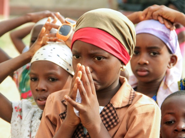 Children pray as members of the Christian community take part in a protest against the killing of people by suspected herdsmen in Makurdi, north-central Nigeria, on April 29, 2018. - On April 24, 2018, at least Eighteen people, including two Catholic priests, were killed in an attack on a church near the state capital, Makurdi, which was blamed on pastors.  Eleven ethnic Hausa merchants were killed in Makurdi in retaliation.  Thousands of people have been killed over decades in clashes between cattle herders and farmers over land and water, with the conflict polarized along religious and ethnic lines.