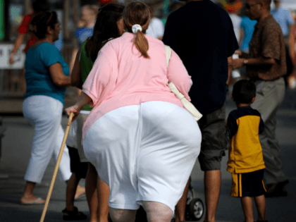 An overweight woman walks at the 61st Montgomery County Agricultural Fair on August 19, 2009 in Gaithersburg, Maryland. At USD 150 billion, the US medical system spends around twice as much treating preventable health conditions caused by obesity than it does on cancer, Health Secretary Kathleen Sebelius said. Two-thirds of …