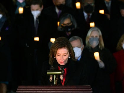 Speaker of the US House of Representatives Nancy Pelosi (C), D-CA, bows her head during a minute of silence during a prayer vigil on the first anniversary of the assault on the US Capitol, on the East Steps of the Capitol in Washington, DC on January 6, 2022. (Photo by …