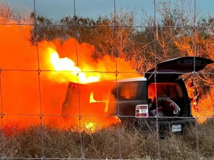 A human smuggler's vehicle catches fire in South Texas after the driver ran through a rancher's fence while fleeing apprehension. (U.S. Border Patrol/Rio Grande Valley Sector)