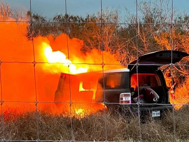 A human smuggler's vehicle catches fire in South Texas after the driver ran through a rancher's fence while fleeing apprehension. (U.S. Border Patrol/Rio Grande Valley Sector)