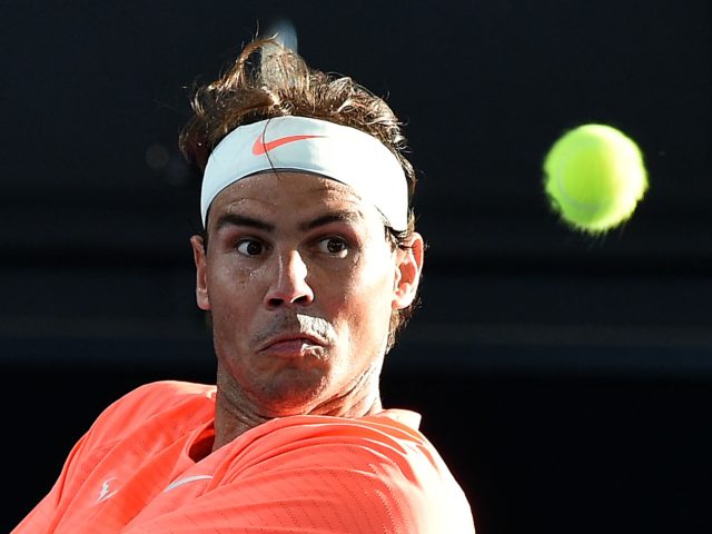 Rafael Nadal of Spain hits a return against Dominic Thiem of Austria during the 'A Day at