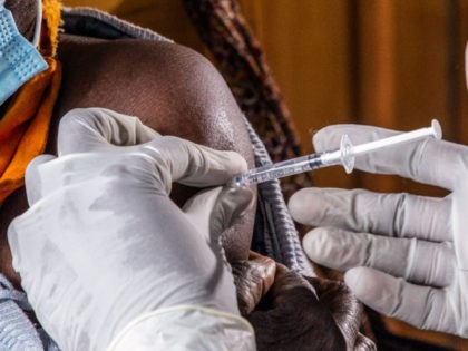 An eldery woman receives the first injection of Oxford AstraZeneca Covid-19 vaccine at Muyumbu Health Center in Rwamagana, East Kigali, on March 5, 2021. (Photo by - / AFP) (Photo by -/AFP via Getty Images)