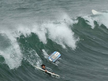 Surfing tsunami (Patrick J. Fallon / AFP / Getty)