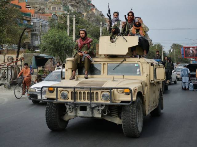 Taliban fighters atop a Humvee vehicle take part in a rally in Kabul on August 31, 2021 as they celebrate after the US pulled all its troops out of the country to end a brutal 20-year war -- one that started and ended with the hardline Islamist in power. (Photo by Hoshang Hashimi / AFP) (Photo by HOSHANG HASHIMI/AFP via Getty Images)