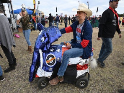 A supporter rides a scooter decked out like an elephant, symbol of the Republican party, as he attends former U.S. President Donald Trump's first rally of the year, January 15, 2022, on the grounds of the Canyon Moon Ranch festival in Florence, Arizona, southeast of Phoenix. - Thousands of Donald …