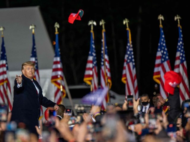 Trump throws cap at rally (Brandon Bell / Getty)
