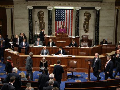 Members walk on the floor as voting begins in the House of Representatives in the first ar