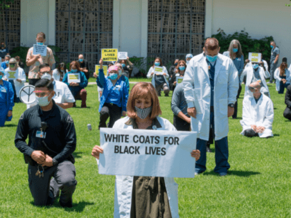 Doctors, nurses and other health care workers participate in a "White Coats for Black