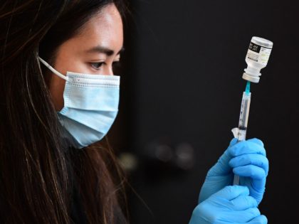 A Covid-19 vaccine is prepared for administration ahead of a free distribution of over the counter rapid Covid-19 test kits to people receiving their vaccines or boosters at Union Station in Los Angeles, California on January 7, 2022. - Los Angeles County reported more than 37,000 new coronavirus cases on …