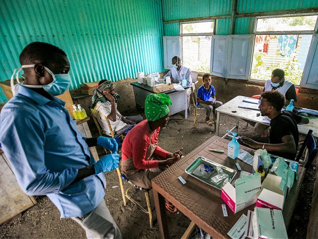 Ethiopian refugees of the Qemant ethnic group sit in a make-shift medical clinic at a camp in the village of Basinga in Basunda district of Sudan's eastern Gedaref region on August 10, 2021. (Photo by ASHRAF SHAZLY / AFP) (Photo by ASHRAF SHAZLY/AFP via Getty Images)