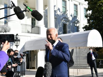 US President Joe Biden speaks with reporters on the South Lawn before departing from the White House on Marine One on January 11, 2022 in Washington, DC. (Photo by NICHOLAS KAMM/AFP via Getty Images)