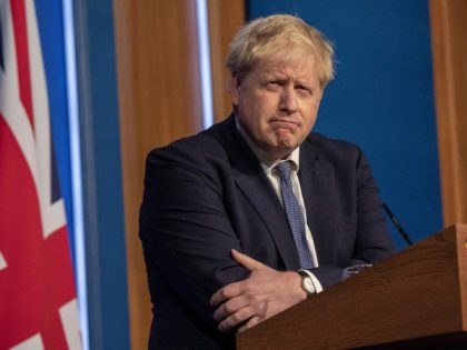 Britain's Prime Minister Boris Johnson speaks during a virtual press conference to update the nation on the status of the Covid-19 pandemic, in the Downing Street briefing room in central London on January 4, 2022. - British hospitals have switched to a "war footing" due to staff shortages caused by …