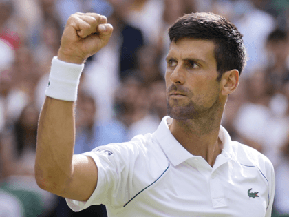 Serbia's Novak Djokovic celebrates after winning a point against Italy's Matteo Berrettini during the men's singles final on day thirteen of the Wimbledon Tennis Championships in London, Sunday, July 11, 2021. (AP Photo/Kirsty Wigglesworth)