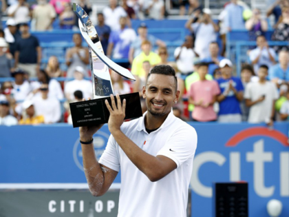 Nick Kyrgios, of Australia, poses for photos with a trophy after defeating Daniil Medvedev, of Russia, in a final match at the Citi Open tennis tournament, Sunday, Aug. 4, 2019, in Washington. (AP Photo/Patrick Semansky)