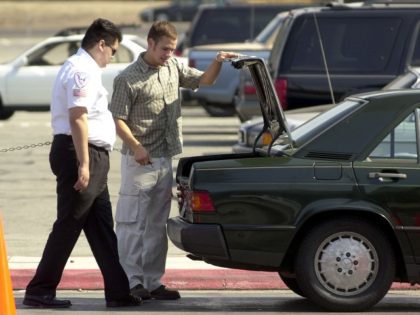 A security guard looks into the trunk of a car before allowing it to park in the short term parking September 24, 2001, at San Jose International Airport in San Jose, CA. Since the terrorist attacks in New York and Washington DC, the FAA has banned parking within 300 feet …