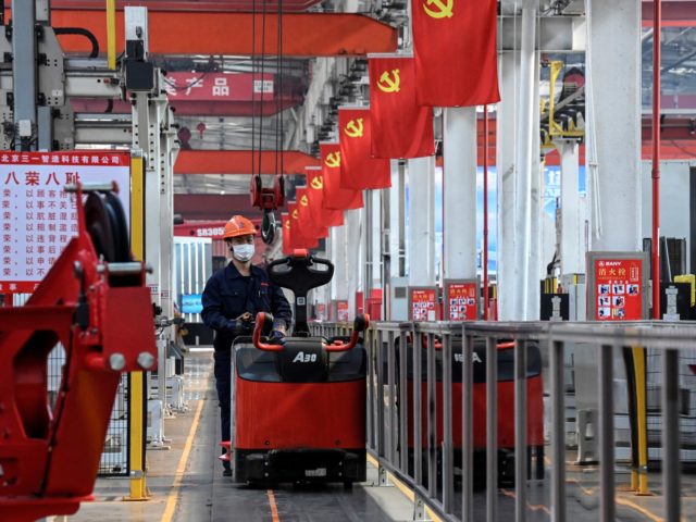 An employee of Chinese heavy equipment manufacturing company Sany works on a machine production line at a factory during a government-organised media tour in Beijing on October 15, 2021. (Photo by Jade GAO / AFP) (Photo by JADE GAO/AFP via Getty Images)