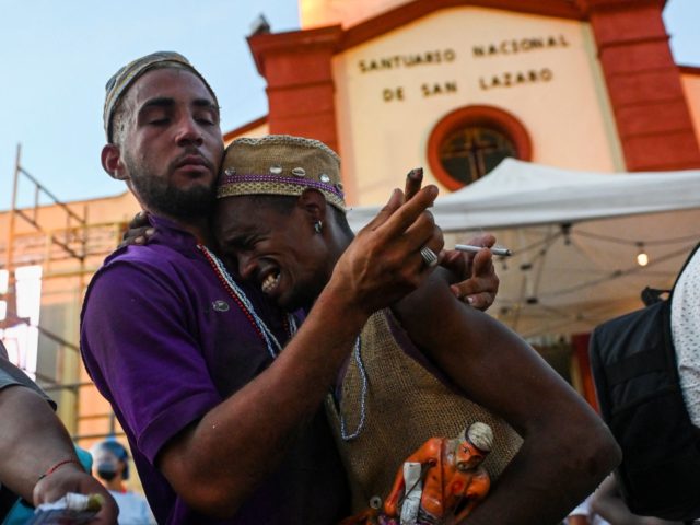 Pilgrims take part in the Saint Lazarus procession at El Rincon Church in Havana, on December 16, 2021. - Thousands of believers gather every year on this date, in this church to fulfill promises to Saint Lazarus - for Christians - or Babalu Aye, for the faithful of the Afro-Cuban …