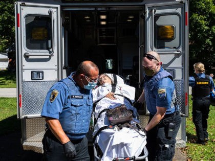 LOUISVILLE, KY - SEPTEMBER 06: (EDITORIAL USE ONLY) Louisville Metro EMS paramedics transport to a woman suspected of experiencing a severe COVID-19 emergency on a medical gurney from her home into an ambulance on September 6, 2021 in Louisville, Kentucky. Kentucky is experiencing a surge in COVID-19 cases, having recently …
