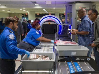 MIAMI, FLORIDA - MAY 21: Transportation Security Administration (TSA) agents help travelers place their bags through the 3-D scanner at the Miami International Airport on May 21, 2019 in Miami, Florida. TSA has begun using the new 3-D computed tomography (CT) scanner in a checkpoint lane to detect explosives and …