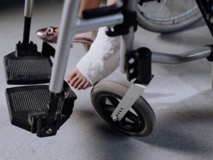 Girl with broken bone in wheelchair