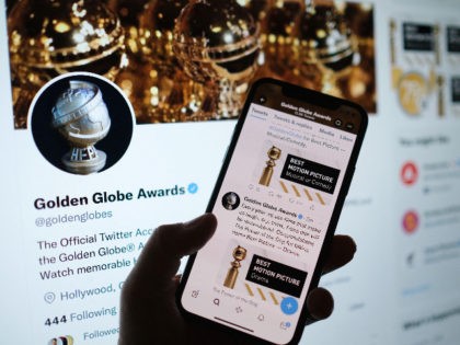 This illustration photo shows a person checking the Golden Globe Awards online via the Golden Globes Twitter account, in Los Angeles, January 9, 2022. - "The Power of the Dog" and "West Side Story" on took the top film prizes at an untelevised Golden Globes, largely ignored by Hollywood, where …