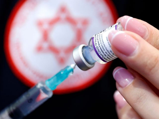 A medic prepares a dose of the Pfizer-BioNTech vaccine against the coronavirus at a private nursing home in the Israeli central coastal city of Netanya on January 5, 2022. - Israel began on January 3 administering fourth Covid vaccine shots to people over 60 and health workers amid a surge …