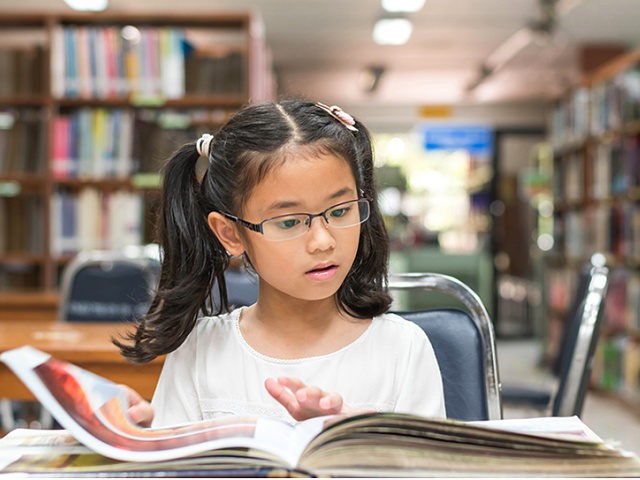 elementary student reads school library