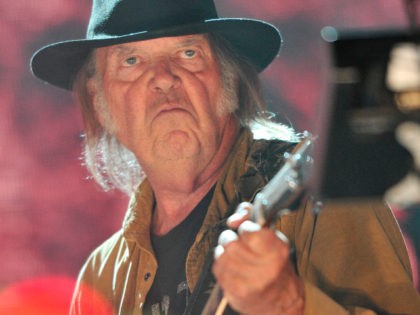 Neil Young performs at Farm Aid 30 at FirstMerit Bank Pavilion at Northerly Island on Saturday, Sept. 19, 2015, in Chicago. (Photo by Rob Grabowski/Invision/AP)