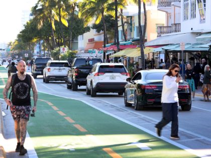 MIAMI BEACH, FLORIDA - JANUARY 24: Cars drive along Ocean Drive after the city reopened it to one lane of traffic flowing southbound on January 24, 2022 in Miami Beach, Florida. The street opened nearly two years after it was closed due to the COVID-19 pandemic and the need to …