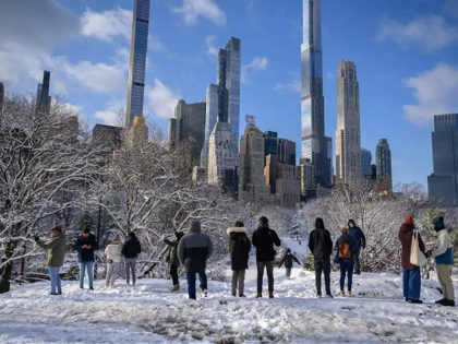 People stand at a viewpoint in Central Park after the first snow storm of the season on January 7, 2022 in New York City. (Photo by Ed JONES / AFP) (Photo by ED JONES/AFP via Getty Images)