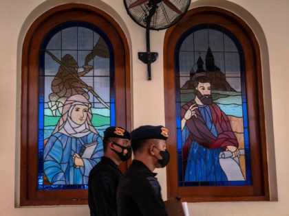 Anti-terror police personnel conduct a security sweep at a church on Christmas Eve in Surabaya on December 24, 2021. (Photo by JUNI KRISWANTO / AFP) (Photo by JUNI KRISWANTO/AFP via Getty Images)