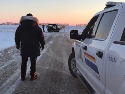 Canadian police search an area where an Indian migrant family was found dead just north of the U.S. border. (Royal Canadian Mounted Police)