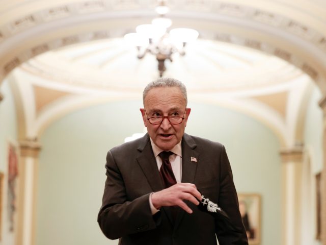 WASHINGTON, DC - DECEMBER 07: U.S. Senate Majority Leader Chuck Schumer (D-NY) takes his face mask off to speak to reporters outside the Senate Chambers of the Capitol on December 07, 2021 in Washington, DC. Schumer updated reporters on the agreement being made with Senate Republicans to pass legislation to …