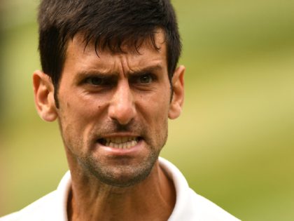 Serbia's Novak Djokovic reacts against Spain's Rafael Nadal during the continuation of their men's singles semi-final match on the twelfth day of the 2018 Wimbledon Championships at The All England Lawn Tennis Club in Wimbledon, southwest London, on July 14, 2018. - RESTRICTED TO EDITORIAL USE (Photo by Glyn KIRK …