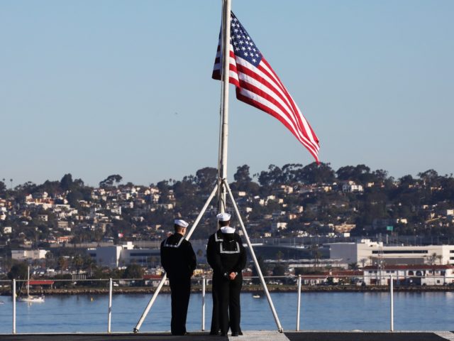 CORONADO, CALIFORNIA - JANUARY 18: U.S. Navy sailors prepare to take down the flag on the flight deck of the USS Nimitz (CVN 68) aircraft carrier on January 18, 2020 in Coronado, California. The USS Nimitz is currently conducting routine operations and training at sea. The nuclear-powered aircraft carrier holds …