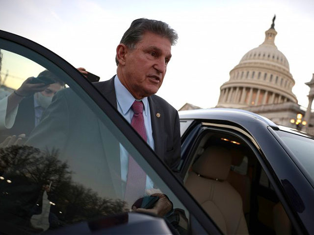 WASHINGTON, DC - DECEMBER 14: Sen. Joe Manchin (D-WV) is followed to his car by reporters after participating in a vote at the U.S. Capitol Building on December 14, 2021 in Washington, DC. The Senate voted to pass legislation raising the national debt limit, which will now move to the …